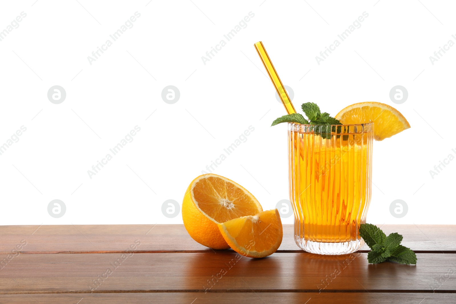 Photo of Glass of tasty refreshing drink with straw and fresh fruit on wooden table against white background