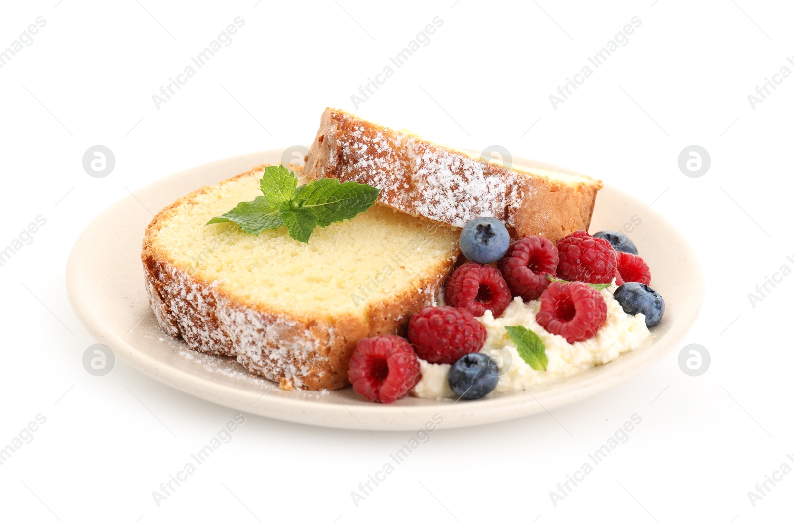 Photo of Freshly baked sponge cake, whipped cream, berries and mint isolated on white