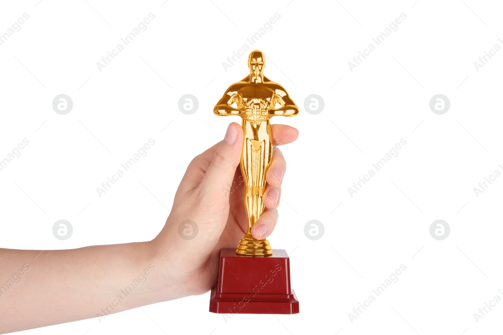 Photo of Woman holding golden trophy in shape of human figure against white background, closeup