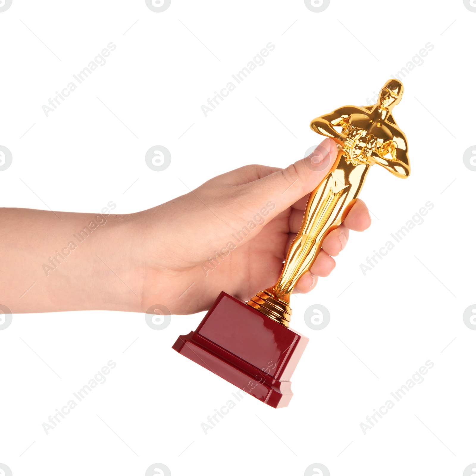 Photo of Woman holding golden trophy in shape of human figure against white background, closeup