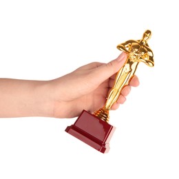 Photo of Woman holding golden trophy in shape of human figure against white background, closeup