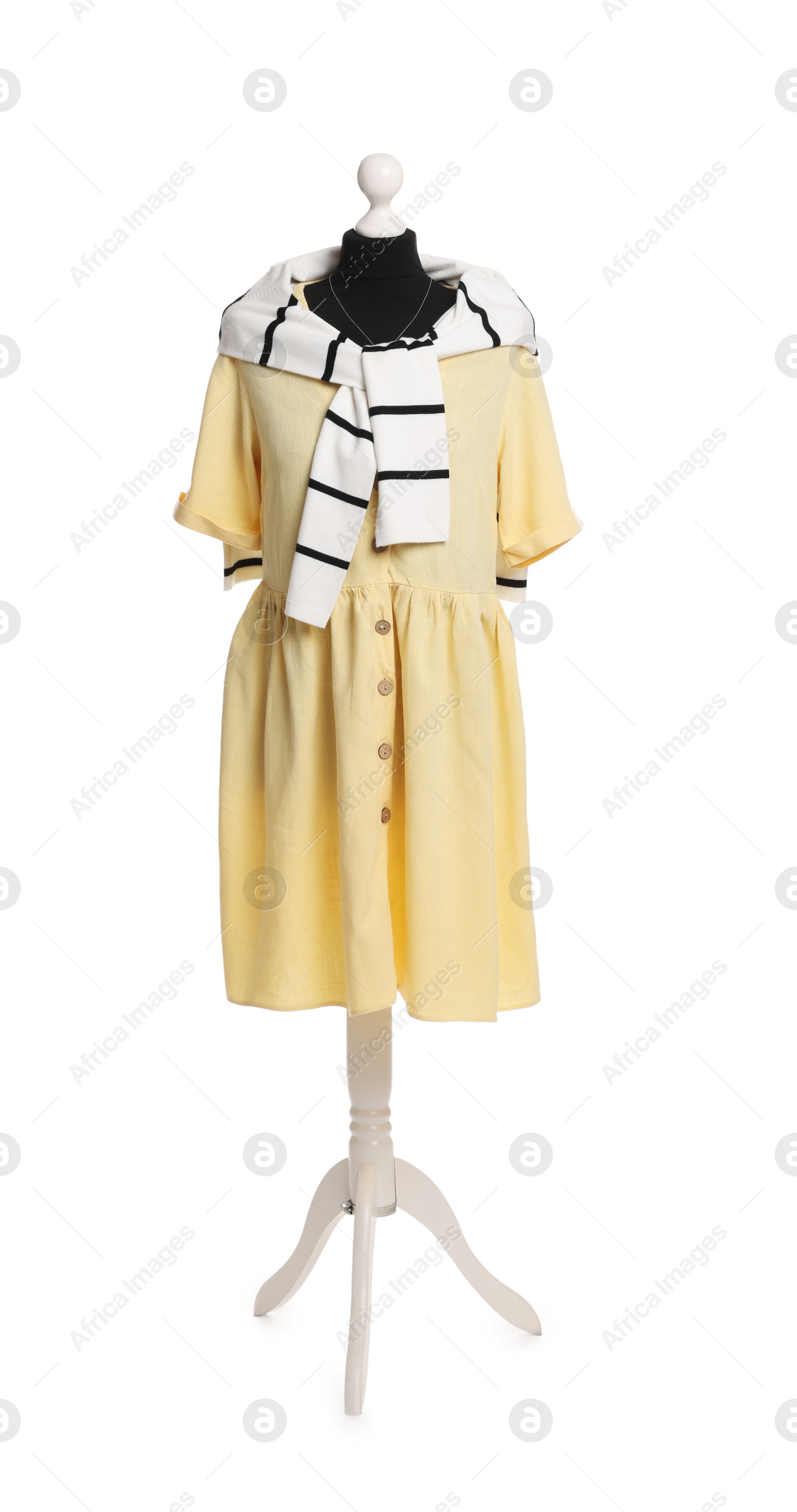 Photo of Female mannequin with stylish yellow dress and striped jumper isolated on white