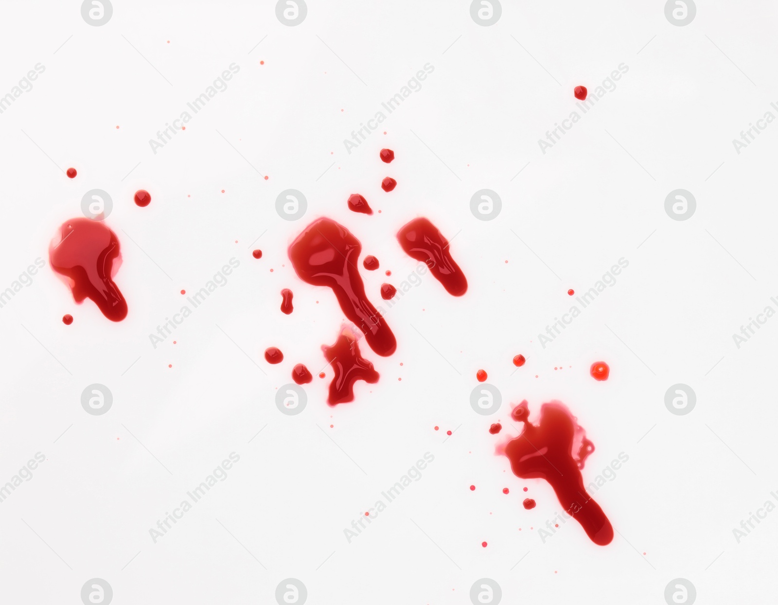 Photo of Stains of blood on white background, top view