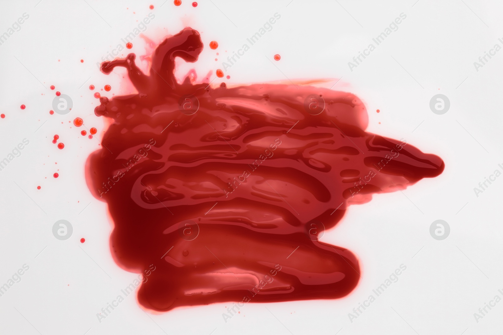 Photo of Stain of blood on white background, top view