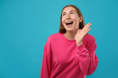 Photo of Smiling girl with braces on light blue background, space for text