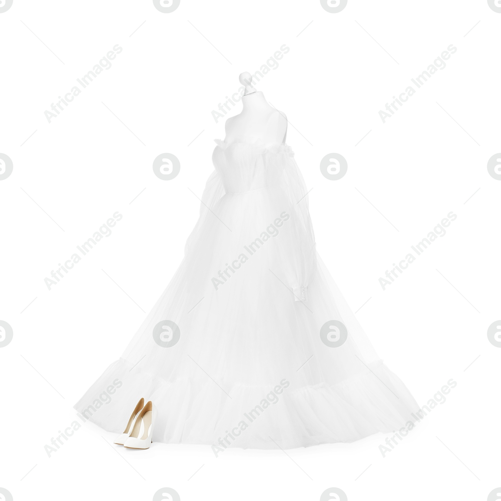 Photo of Mannequin with beautiful wedding dress and shoes isolated on white