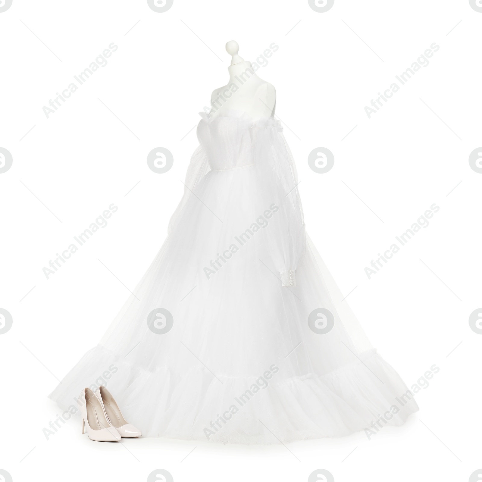 Photo of Mannequin with beautiful wedding dress and shoes isolated on white