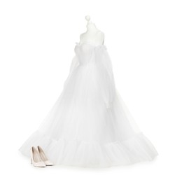 Photo of Mannequin with beautiful wedding dress and shoes isolated on white