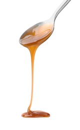 Photo of Tasty caramel sauce dripping from spoon on white background, closeup