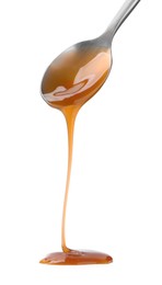 Photo of Tasty caramel sauce dripping from spoon on white background, closeup