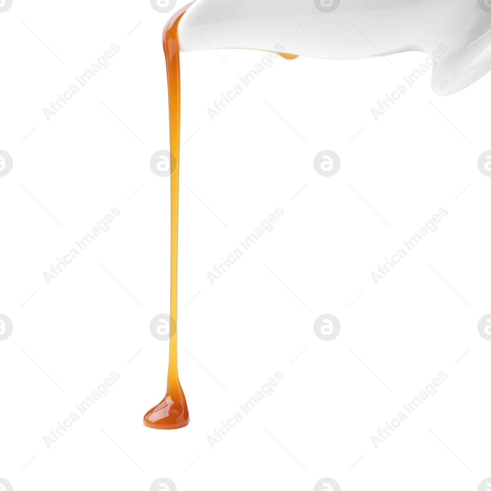 Photo of Tasty caramel sauce dripping on white background, closeup