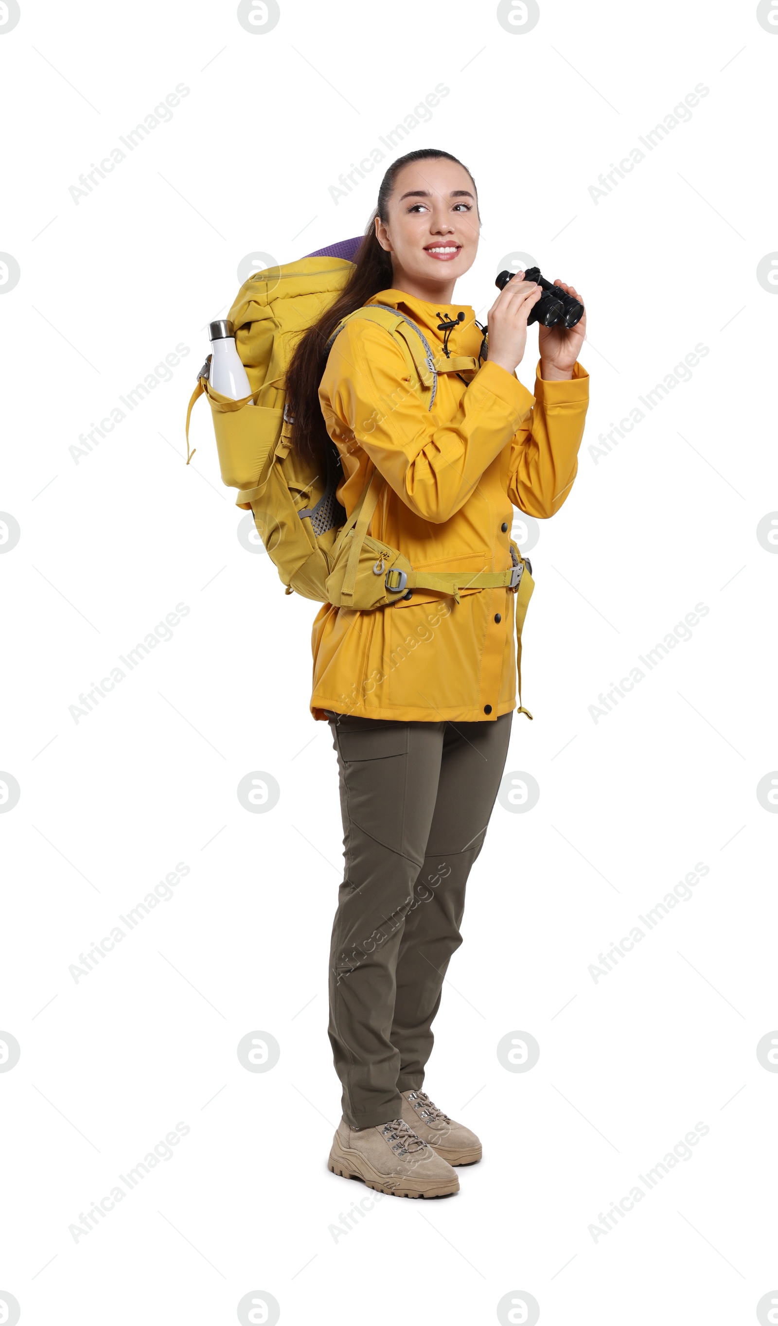 Photo of Smiling young woman with backpack and binoculars on white background. Active tourism