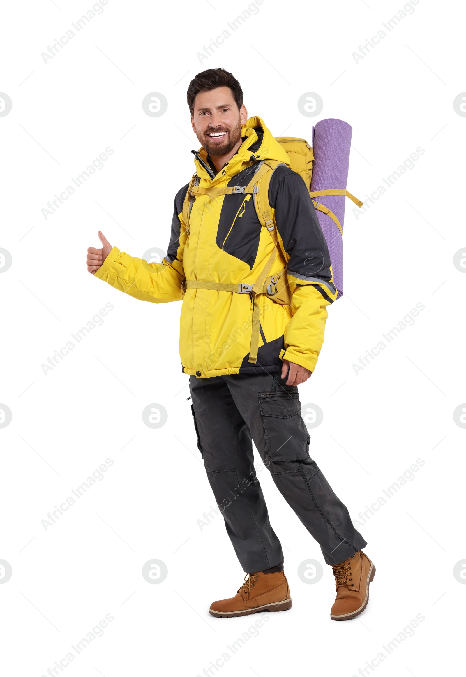 Photo of Happy man with backpack showing thumbs up on white background. Active tourism