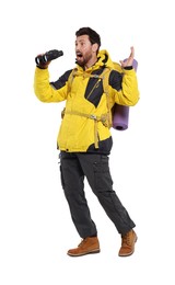 Emotional man with backpack and binoculars on white background. Active tourism