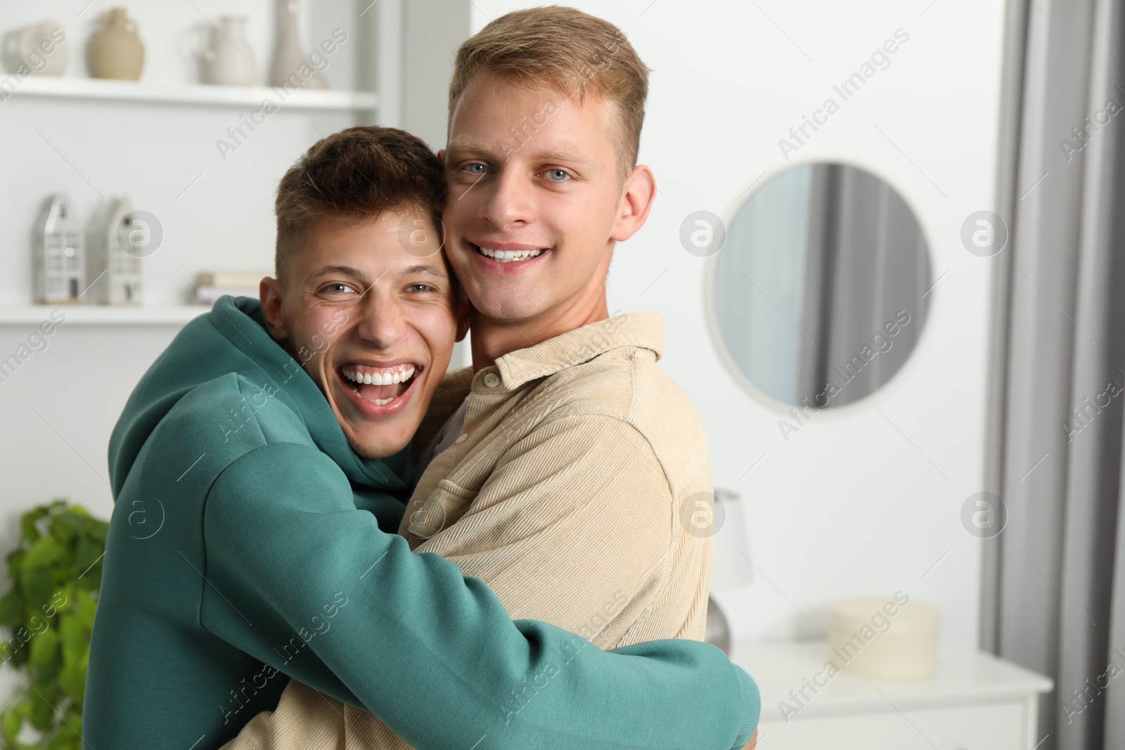 Photo of Family portrait of happy brothers hugging at home. Space for text