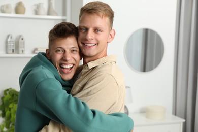 Photo of Family portrait of happy brothers hugging at home. Space for text