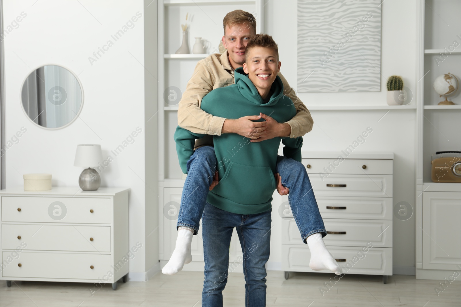 Photo of Family portrait of happy brothers having fun at home