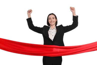 Young businesswoman in suit crossing red finish line on white background