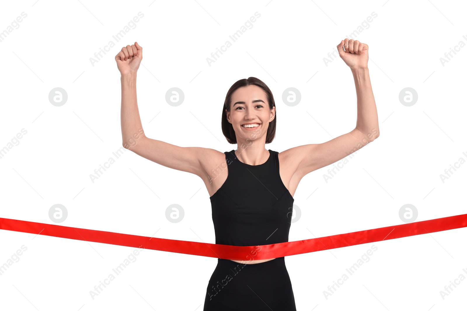 Photo of Beautiful woman in sportswear crossing red finish line on white background