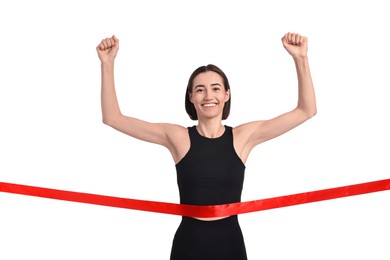 Photo of Beautiful woman in sportswear crossing red finish line on white background