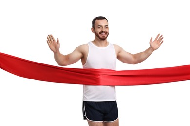 Photo of Handsome young man crossing red finish line on white background