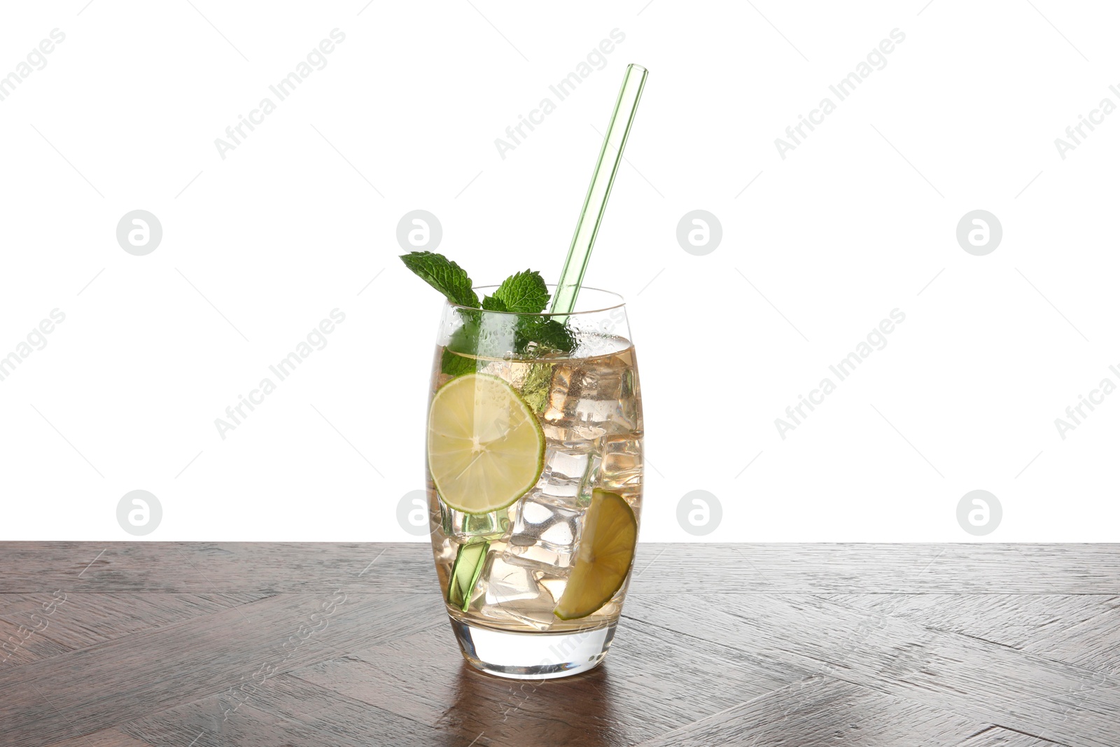 Photo of Glass of tasty refreshing drink and straw on wooden table against white background