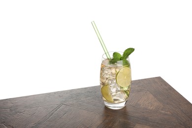 Glass of tasty refreshing drink and straw on wooden table against white background