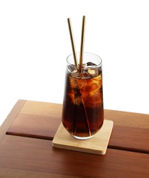 Photo of Glass of tasty refreshing drink and straws on wooden table against white background