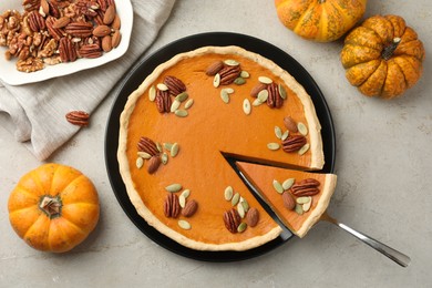 Photo of Tasty homemade pumpkin pie served on grey table, top view