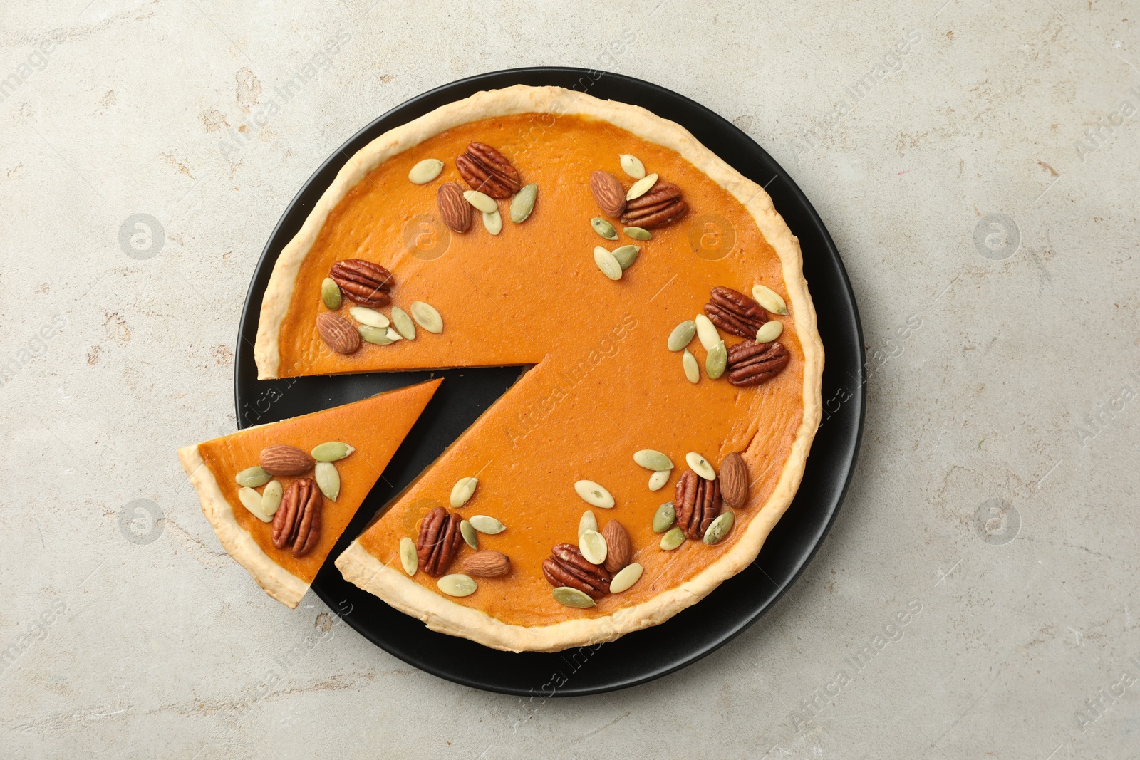 Photo of Tasty homemade pumpkin pie on grey table, top view