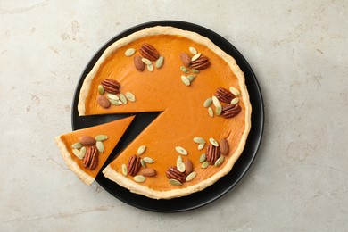 Photo of Tasty homemade pumpkin pie on grey table, top view