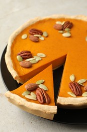 Photo of Tasty homemade pumpkin pie on grey table, closeup