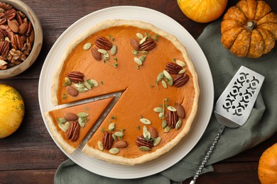 Tasty homemade pumpkin pie served on wooden table, top view