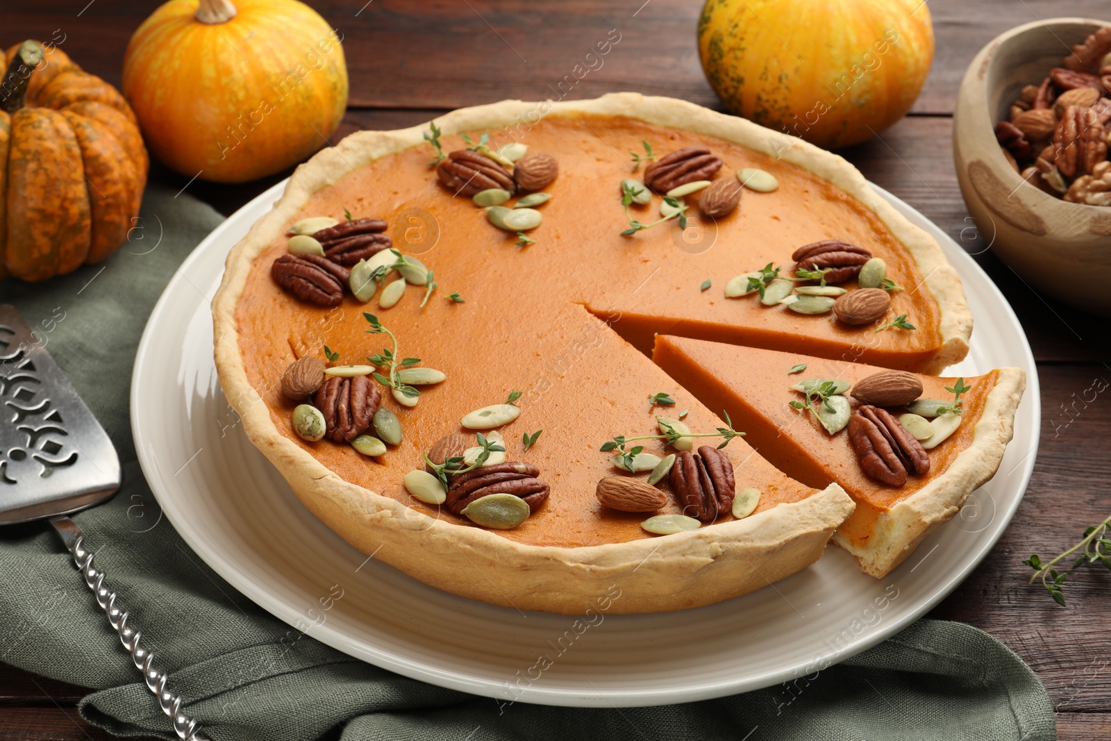 Photo of Tasty homemade pumpkin pie served on wooden table, closeup