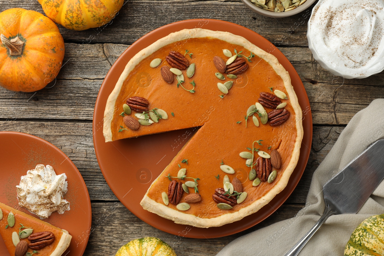 Photo of Tasty homemade pumpkin pie served on wooden table, top view