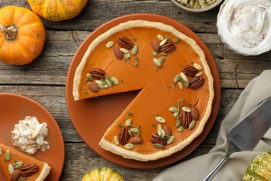 Tasty homemade pumpkin pie served on wooden table, top view