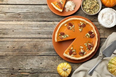 Tasty homemade pumpkin pie served on wooden table, top view. Space for text