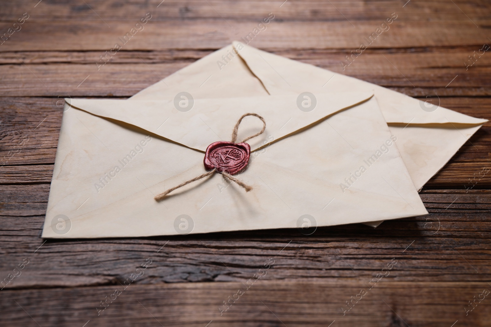 Photo of Old letter envelopes on wooden table, closeup