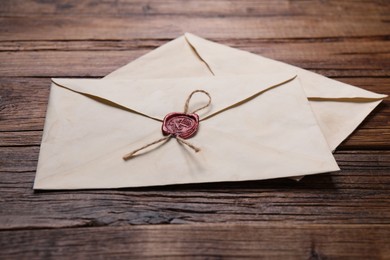 Old letter envelopes on wooden table, closeup