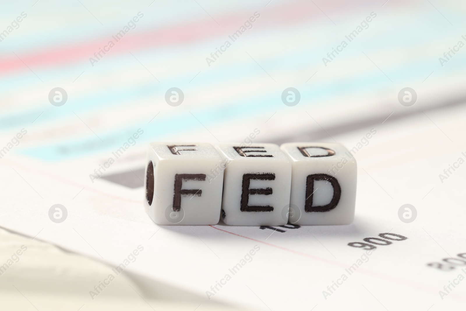 Photo of Cubes with letters Fed (Federal Reserve System) on table, closeup