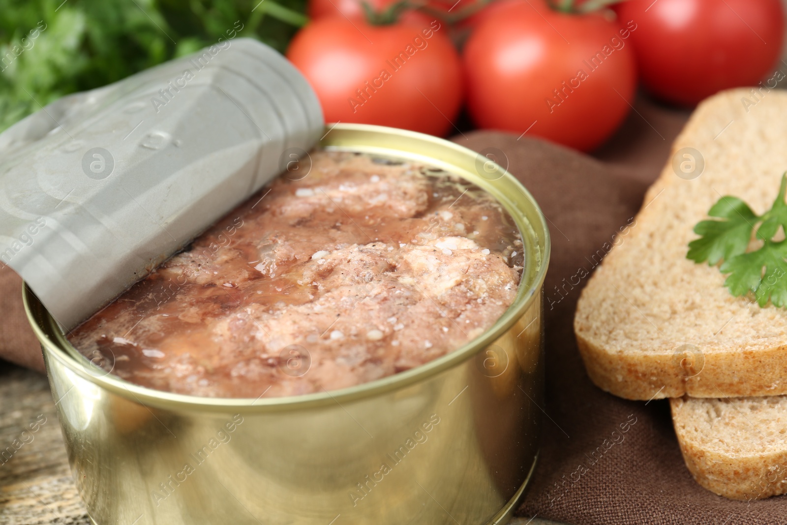 Photo of Canned meat in tin can served on table, closeup