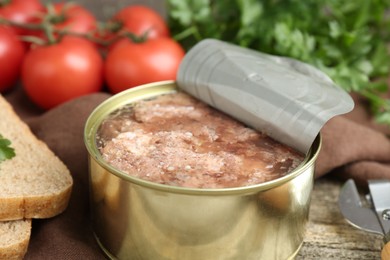 Photo of Canned meat in tin can served on table, closeup