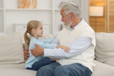 Photo of Grandpa and his granddaughter spending time together at home