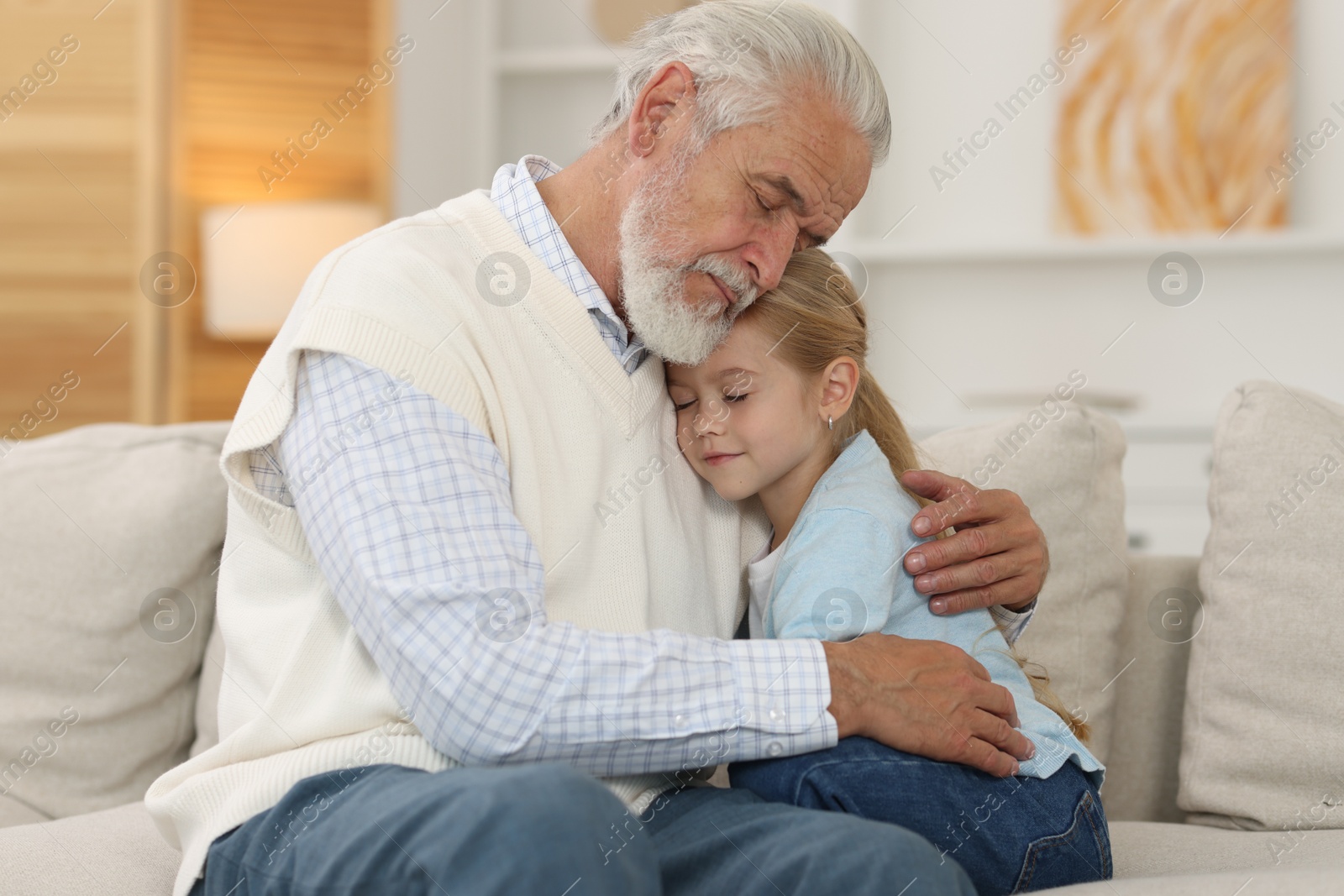 Photo of Grandpa and his granddaughter spending time together at home