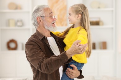 Grandpa and his granddaughter spending time together at home