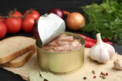 Photo of Canned meat in tin can and other products on table, closeup