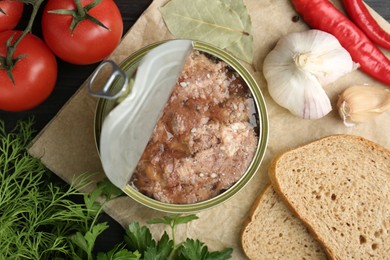 Photo of Canned meat in tin can and other products on table, top view