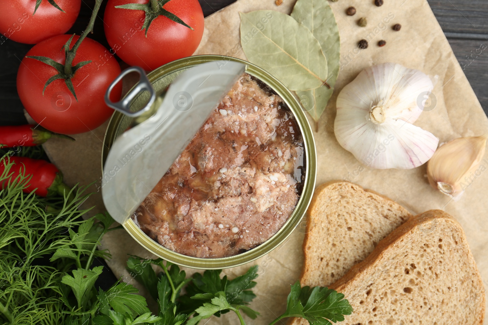 Photo of Canned meat in tin can and other products on table, top view