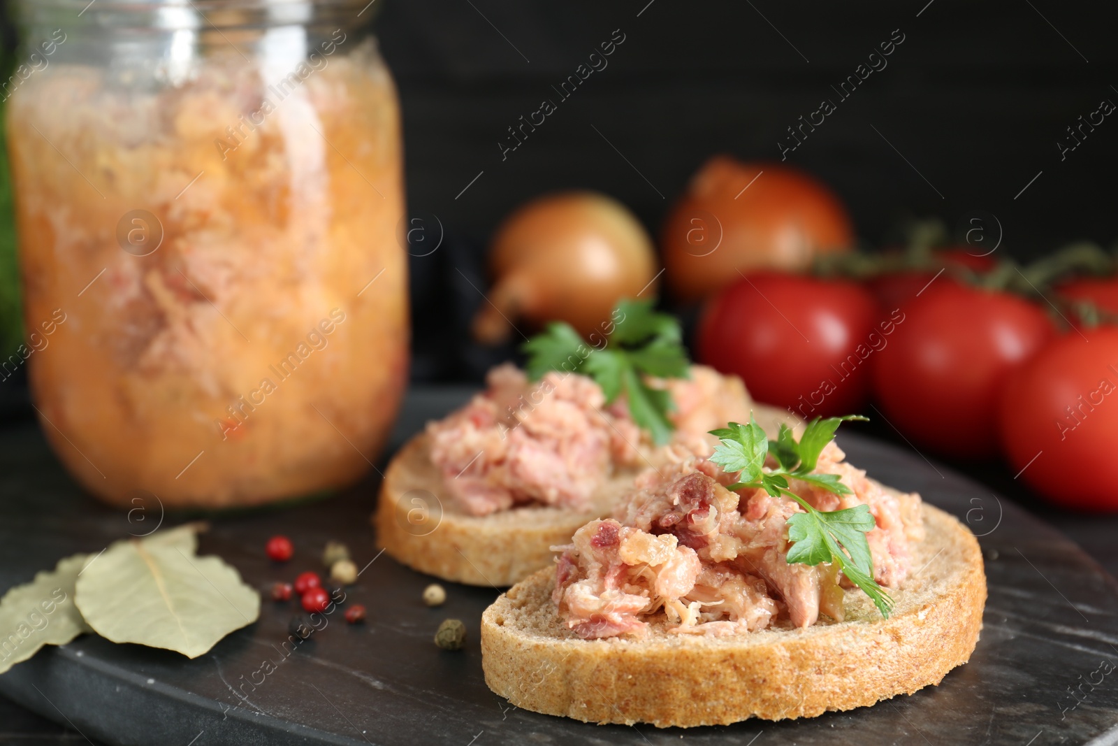 Photo of Sandwiches with canned meat and spices on table, closeup