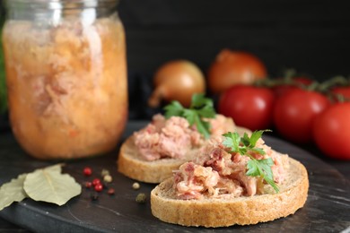 Photo of Sandwiches with canned meat and spices on table, closeup